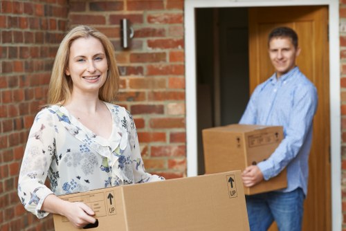 Same day removals team loading furniture in Enfield on a busy residential street