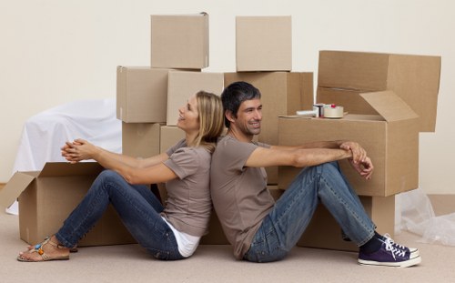 Local moving team handling packing materials and furniture protection