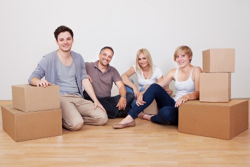 Professional movers coordinating a safe and secure van loading process